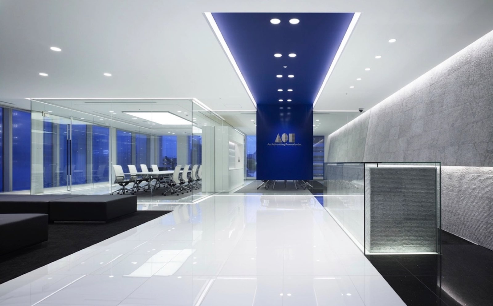 A modern office lobby with polished floors and glass walls